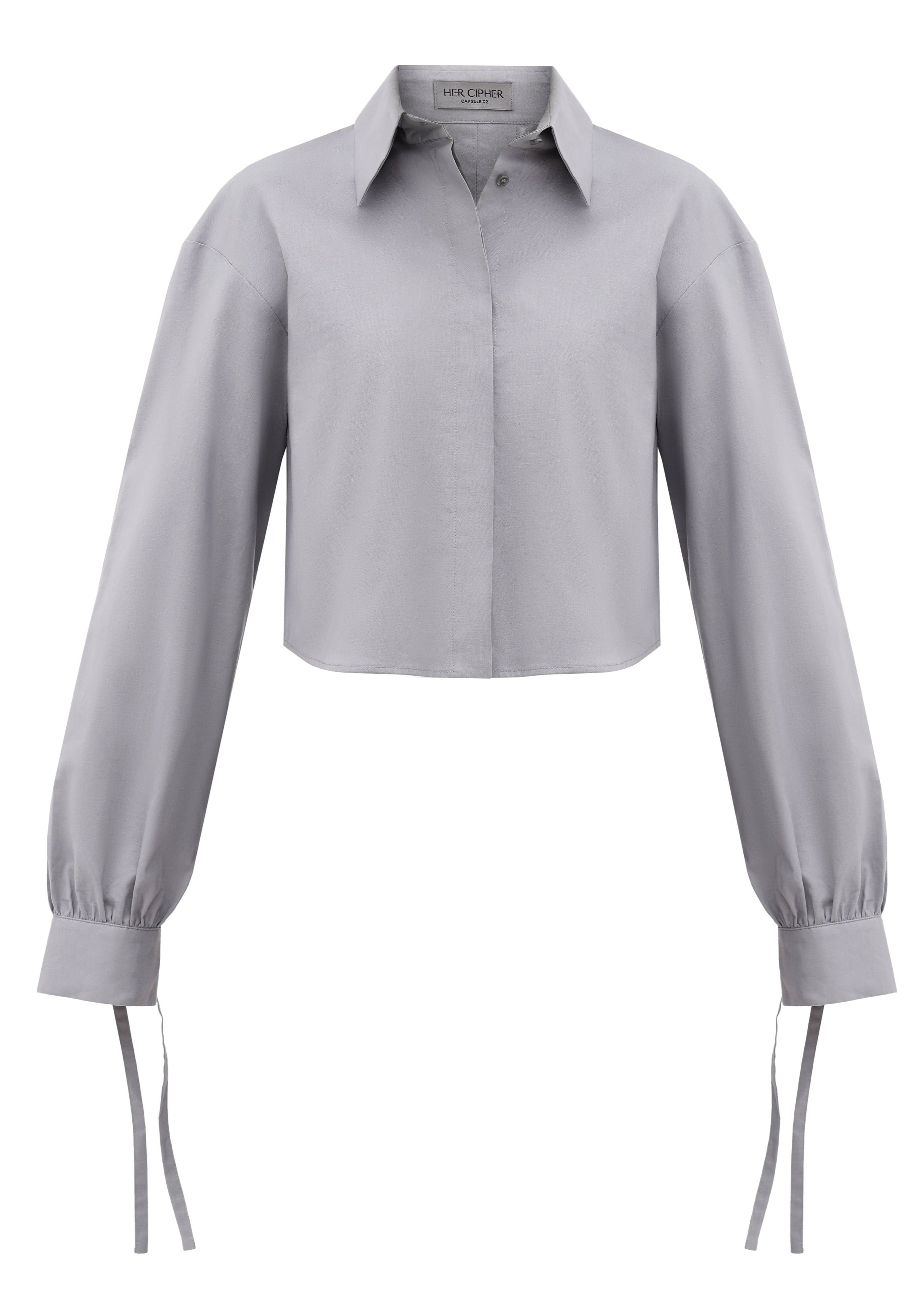 A grey cropped button up shirt created from organic cotton certified with GOTS with tie details on sleeves