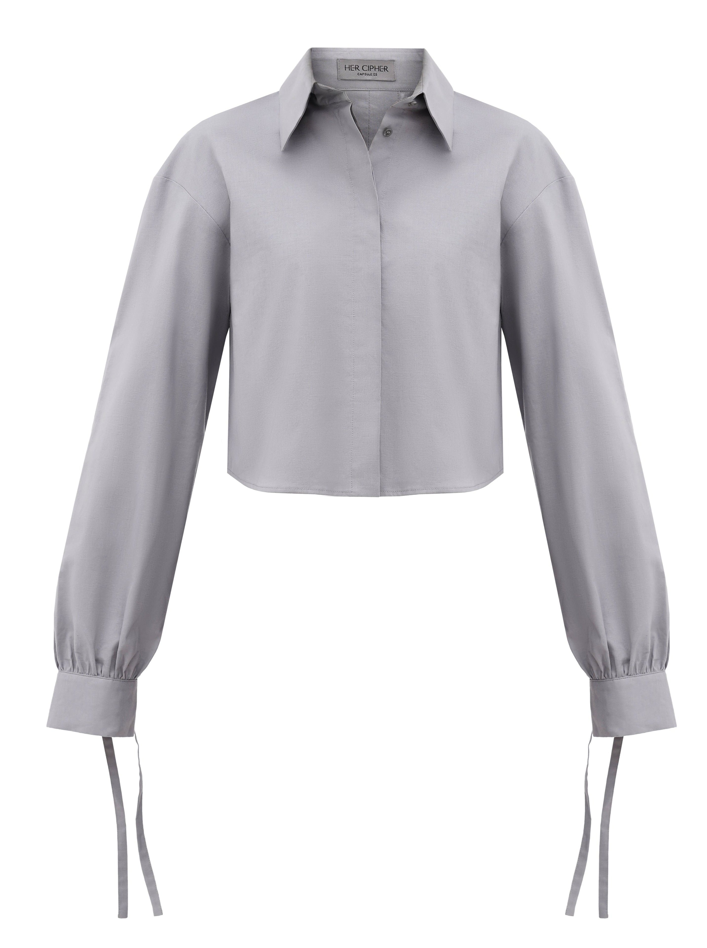 A grey cropped button up shirt created from organic cotton certified with GOTS with tie details on sleeves