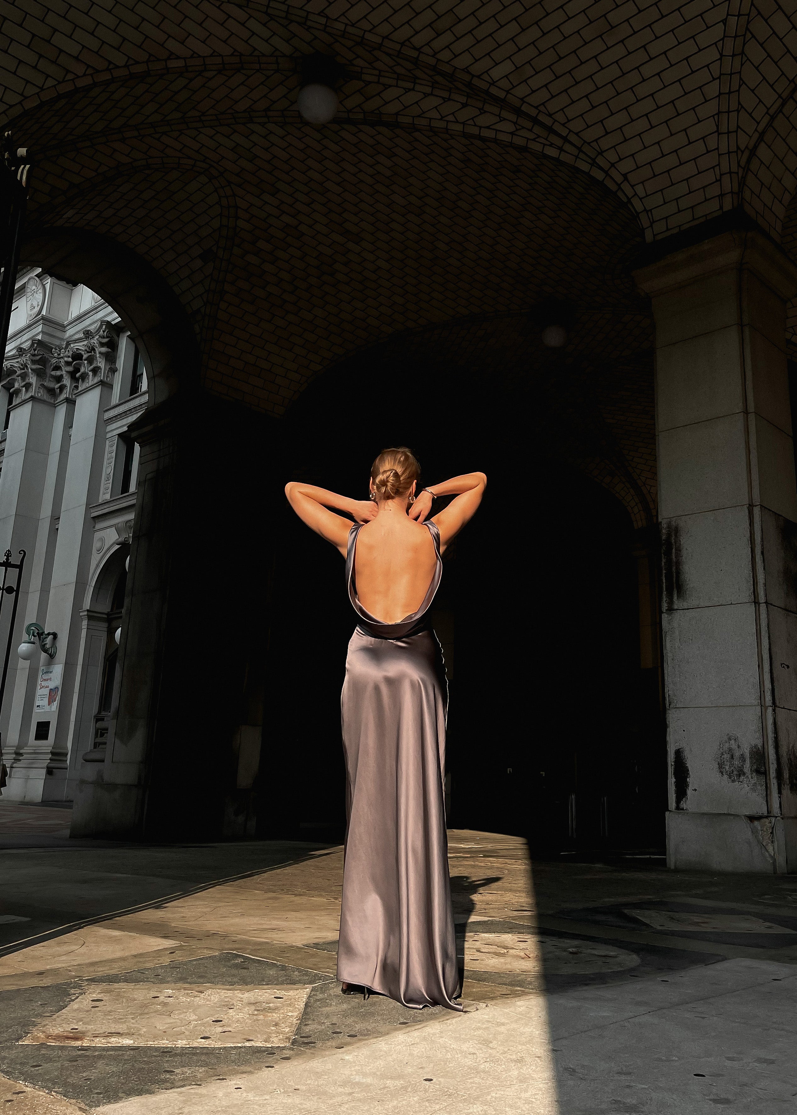 Beautiful model is wearing an open back Moonlight maxi dress created from 100% luxurious silk