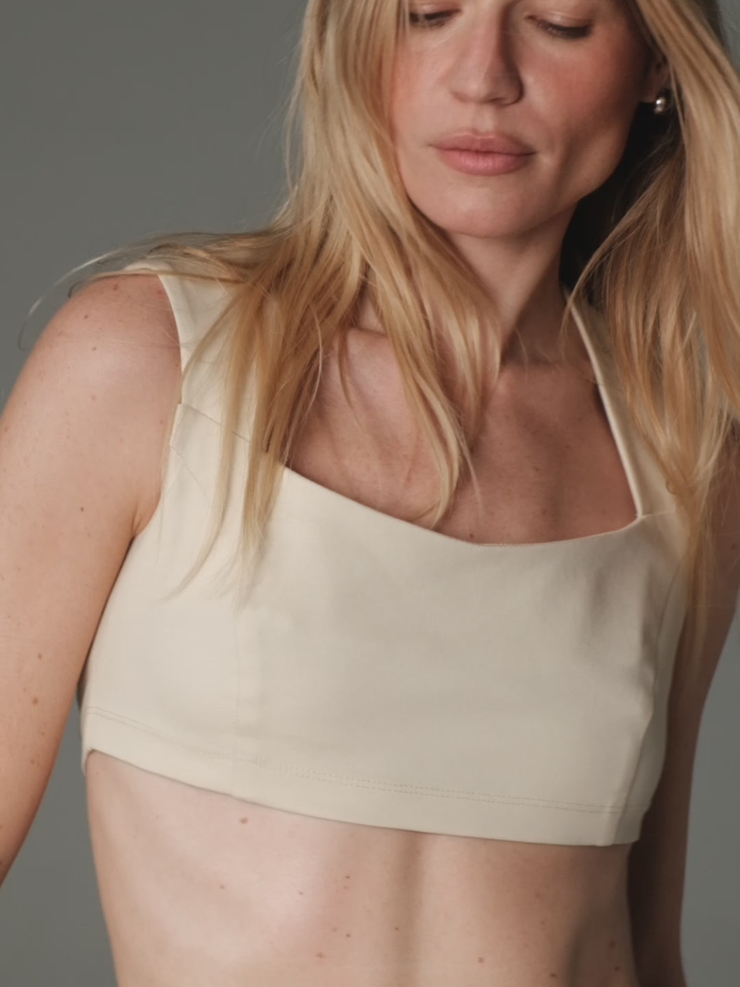 alt="model posing and slowly moving wearing a Soho crop top and silk maxi Siren skirt by Her Cipher"