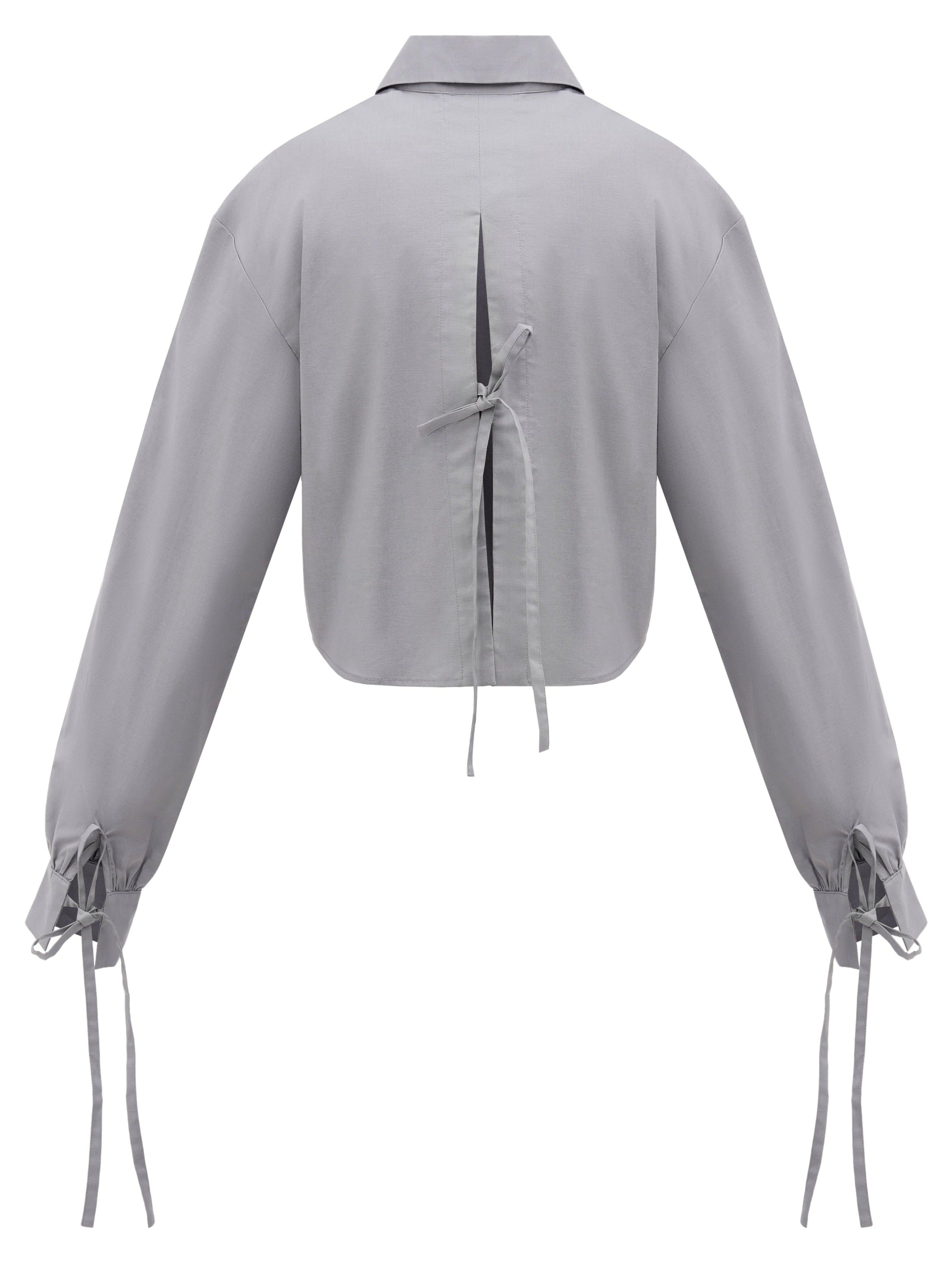 A back of a sustainable organic cotton shirt in grey color with three bow-tie details